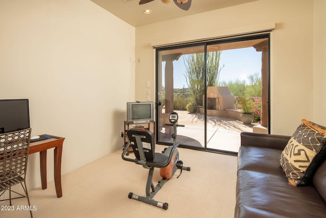 interior space with carpet flooring and ceiling fan