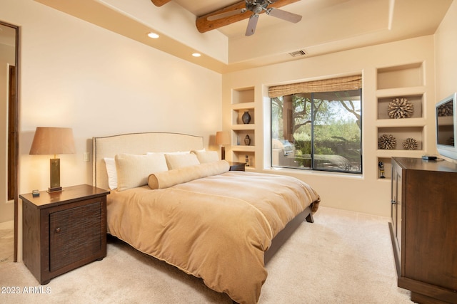 bedroom with ceiling fan, light carpet, and beam ceiling