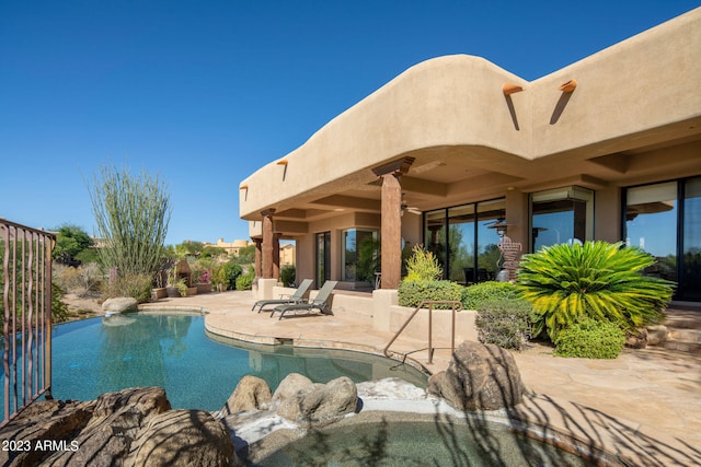 view of swimming pool featuring a patio area and ceiling fan