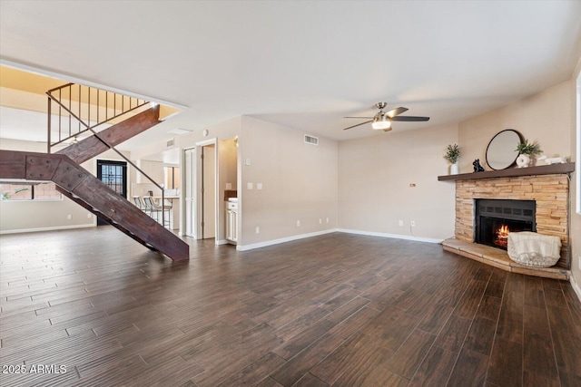 unfurnished living room with ceiling fan, a fireplace, and dark hardwood / wood-style floors