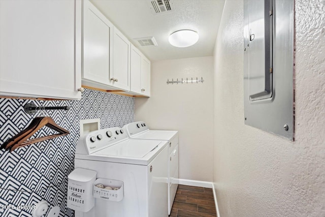 laundry room featuring cabinets, electric panel, and washer and dryer