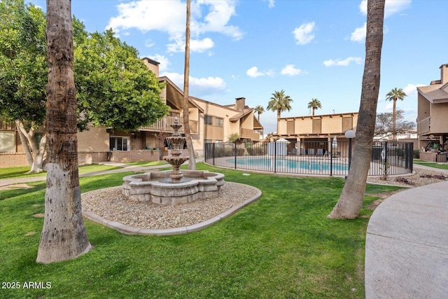 exterior space featuring a pool and a lawn