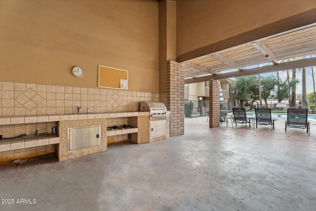 view of patio / terrace with an outdoor kitchen and a grill