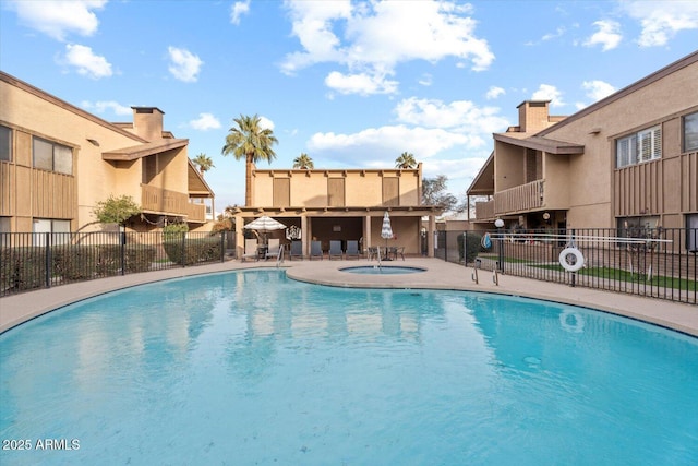 view of pool featuring a patio and a community hot tub