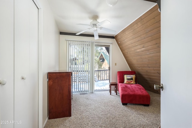 sitting room featuring lofted ceiling, carpet, and a ceiling fan