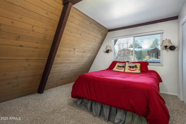 bedroom with carpet flooring and wood walls