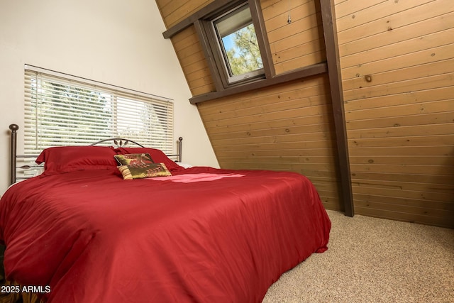 bedroom with wooden walls and carpet flooring