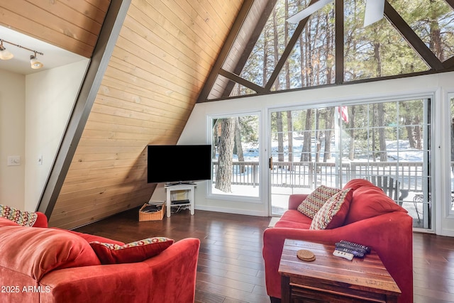 living room featuring dark wood finished floors, track lighting, wooden ceiling, and lofted ceiling with beams