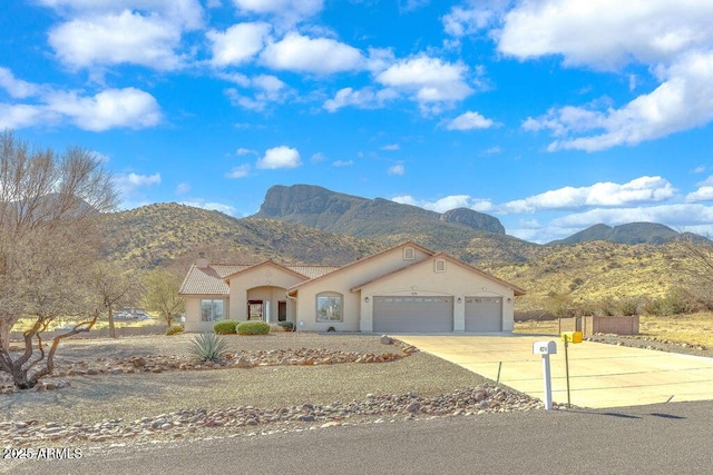 view of front facade featuring a mountain view and a garage