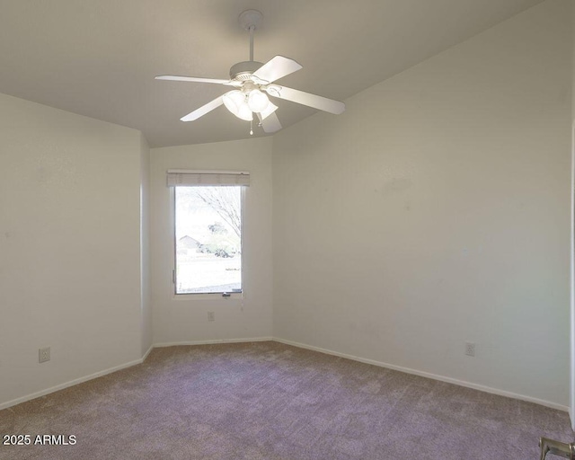 empty room with light colored carpet, vaulted ceiling, and ceiling fan