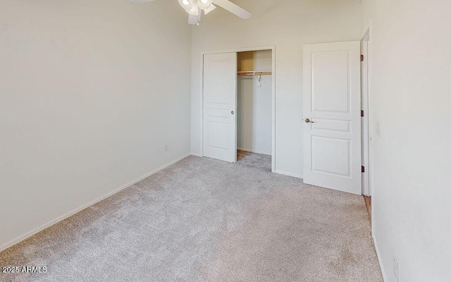 unfurnished bedroom featuring ceiling fan, light colored carpet, and a closet