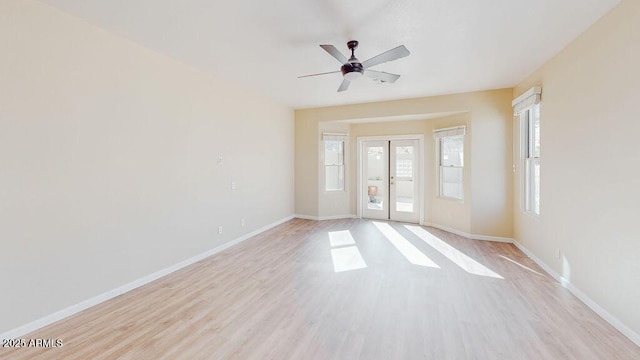 spare room with light hardwood / wood-style floors, french doors, and ceiling fan