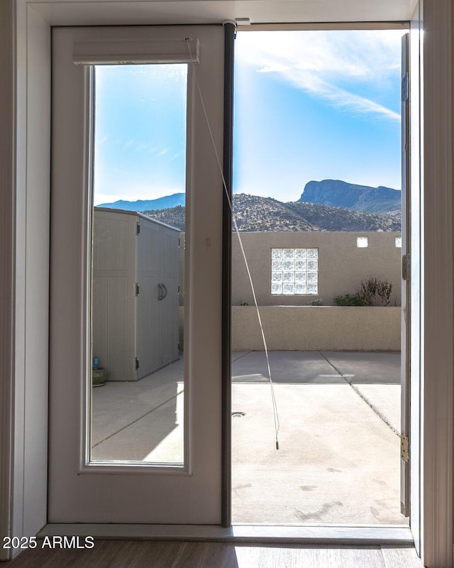 doorway to outside with a mountain view and hardwood / wood-style floors