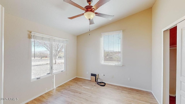 empty room featuring vaulted ceiling, ceiling fan, and light hardwood / wood-style floors