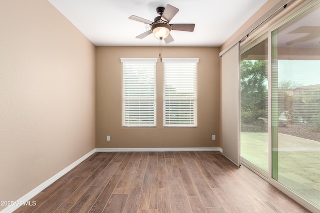 unfurnished room featuring ceiling fan, baseboards, and wood finished floors