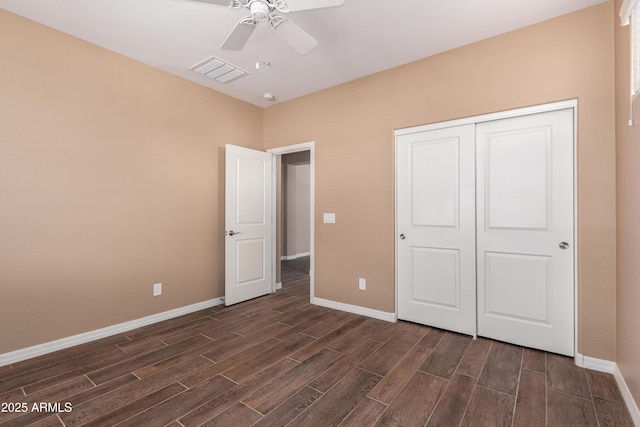 unfurnished bedroom featuring wood finish floors, visible vents, and baseboards