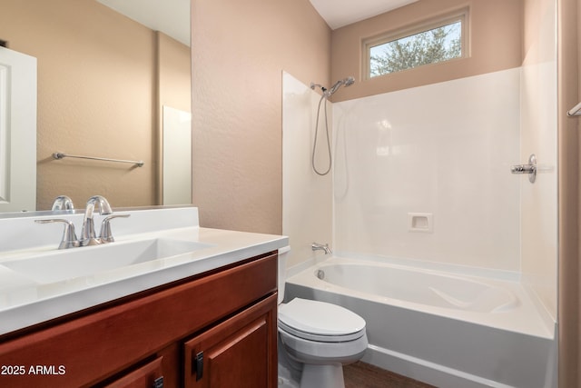 bathroom featuring a textured wall,  shower combination, vanity, and toilet