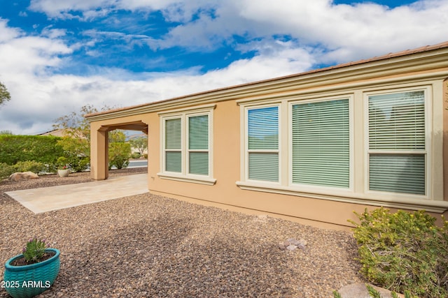 view of property exterior with a patio area and stucco siding