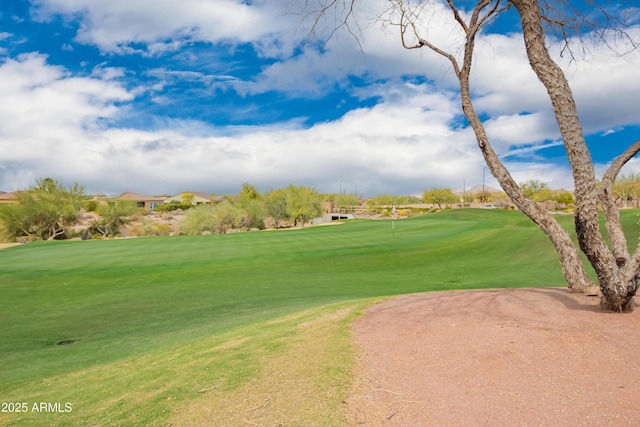 surrounding community featuring view of golf course and a yard