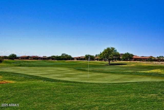 view of home's community with a lawn and golf course view