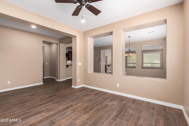 empty room featuring visible vents, baseboards, ceiling fan, and wood finish floors