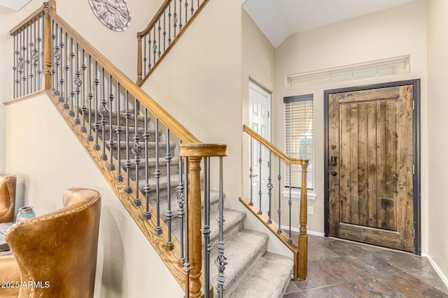 entryway with baseboards, a healthy amount of sunlight, and stairway