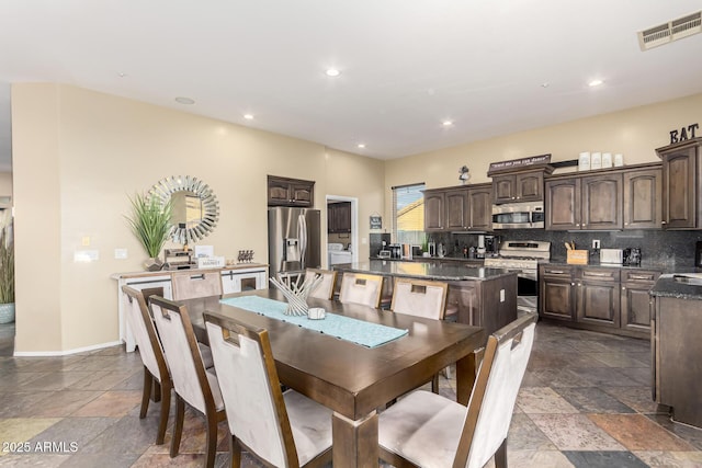 dining room featuring stone tile flooring, baseboards, recessed lighting, and visible vents