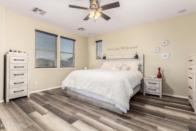 bedroom with baseboards, dark wood-style floors, and visible vents