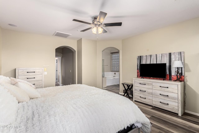 bedroom with wood finished floors, baseboards, visible vents, arched walkways, and ceiling fan