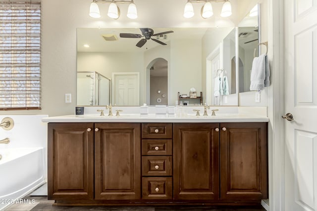 bathroom featuring a shower stall, a sink, a garden tub, a ceiling fan, and double vanity