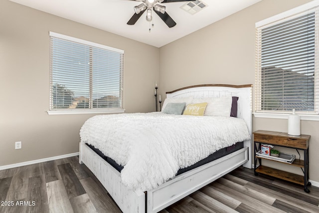 bedroom with wood finished floors, baseboards, and visible vents