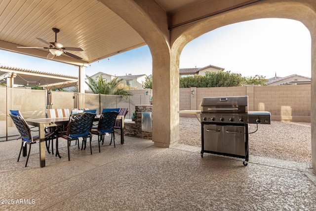 view of patio / terrace with a fenced backyard, area for grilling, ceiling fan, and outdoor dining space