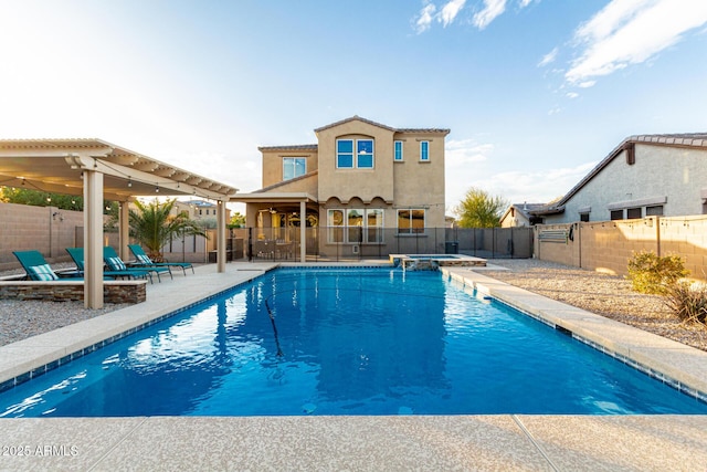 view of swimming pool featuring a fenced backyard, a pool with connected hot tub, a patio, and a pergola