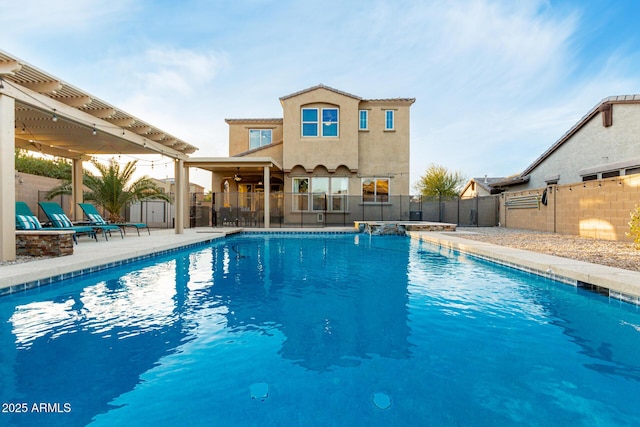view of swimming pool with ceiling fan, a fenced backyard, a storage unit, an outdoor structure, and a patio area