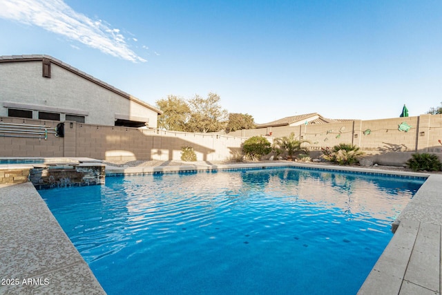 view of pool with a fenced backyard and a pool with connected hot tub