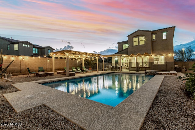 view of swimming pool with a fenced backyard, a fire pit, a pool with connected hot tub, and a patio area