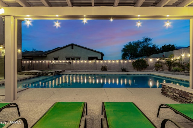 pool at dusk with a fenced backyard, a patio, and a fenced in pool