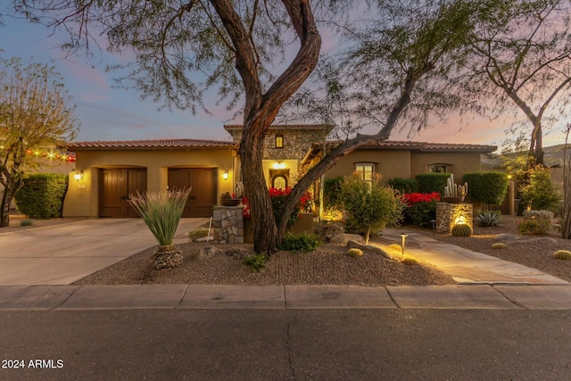 mediterranean / spanish home featuring a garage