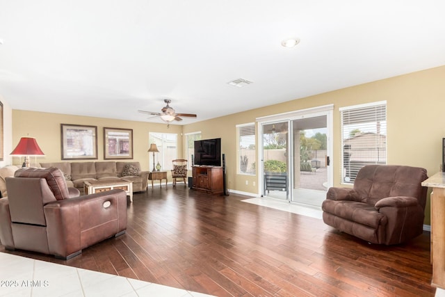 living room with ceiling fan and dark hardwood / wood-style flooring