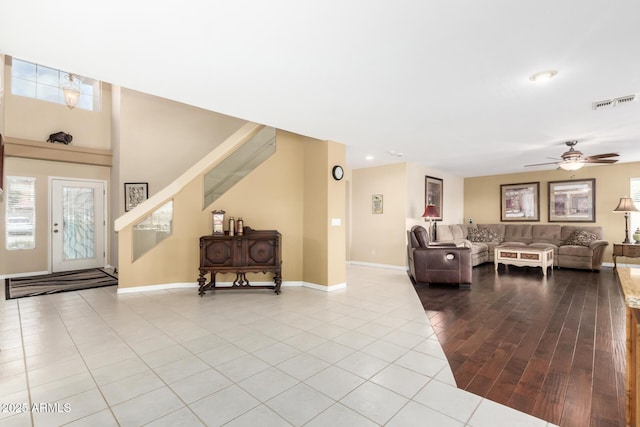 tiled living room featuring ceiling fan