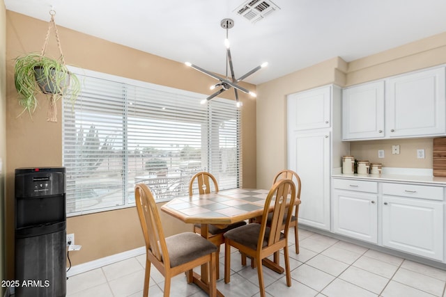 dining room with light tile patterned flooring and an inviting chandelier