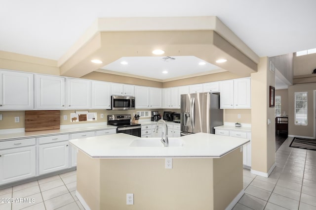 kitchen with white cabinetry, an island with sink, and appliances with stainless steel finishes