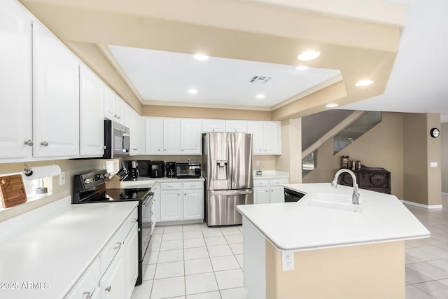 kitchen featuring light tile patterned flooring, sink, appliances with stainless steel finishes, a kitchen island with sink, and white cabinets