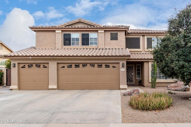 mediterranean / spanish house with a garage