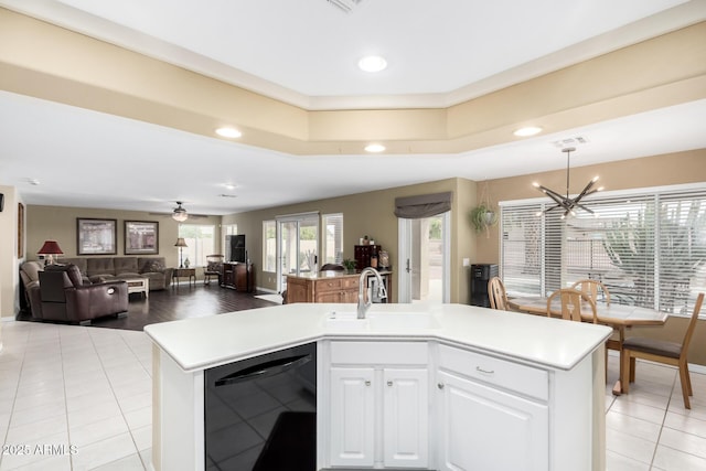 kitchen featuring white cabinets, an island with sink, sink, and black dishwasher