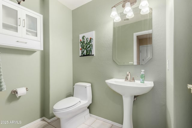 bathroom with tile patterned floors and toilet