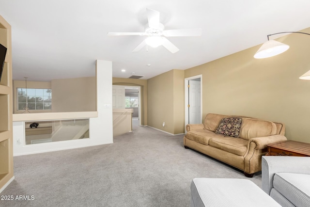 carpeted living room featuring ceiling fan