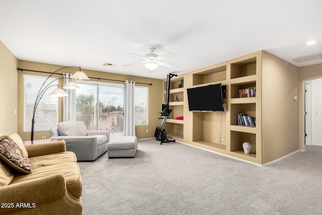 living room with carpet floors, built in features, and ceiling fan