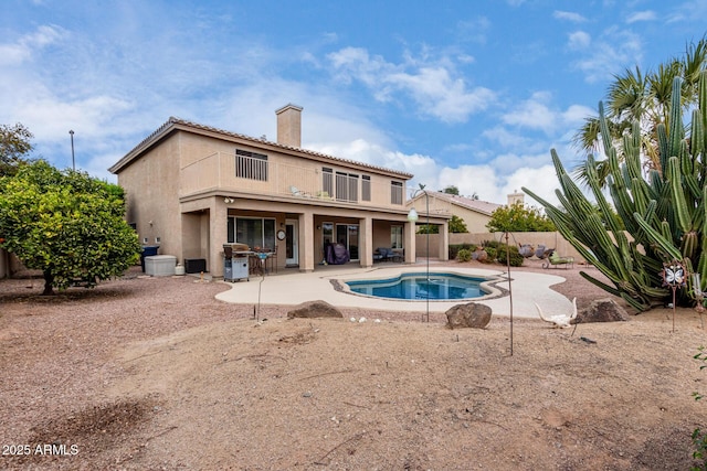 view of pool featuring a grill and a patio area