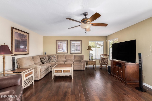 living room featuring ceiling fan and dark hardwood / wood-style flooring